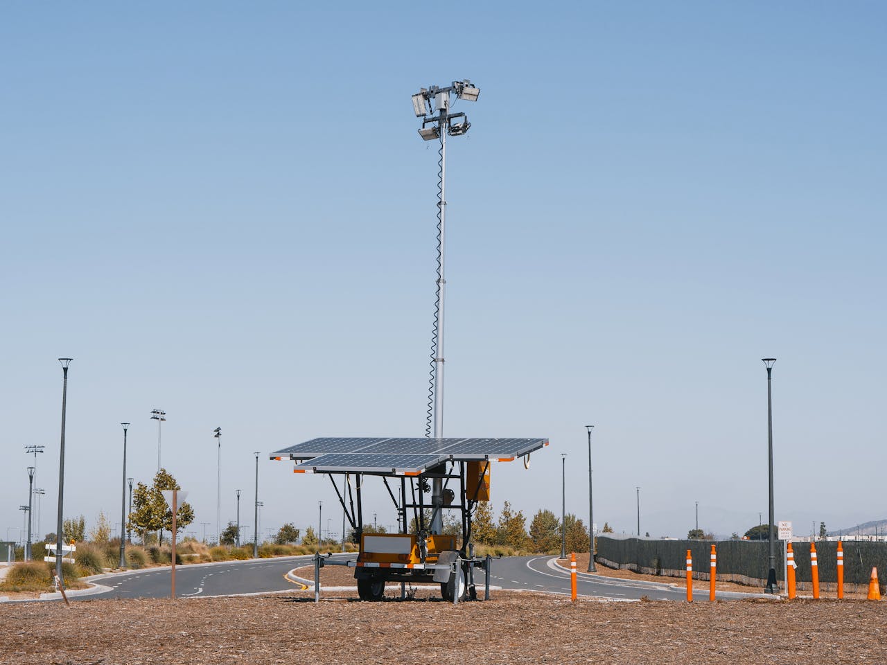 Solar powered streetlights under a clear blue sky, emphasizing renewable energy.